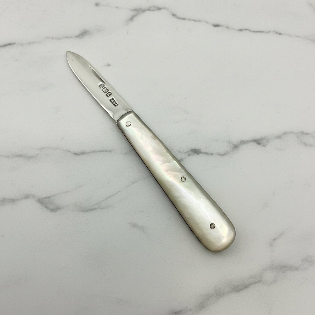 Fruit knife with a decorative handle on a marble surface