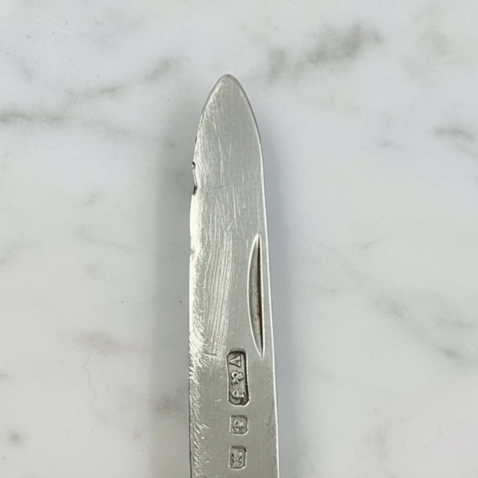 Silver knife on a marble surface