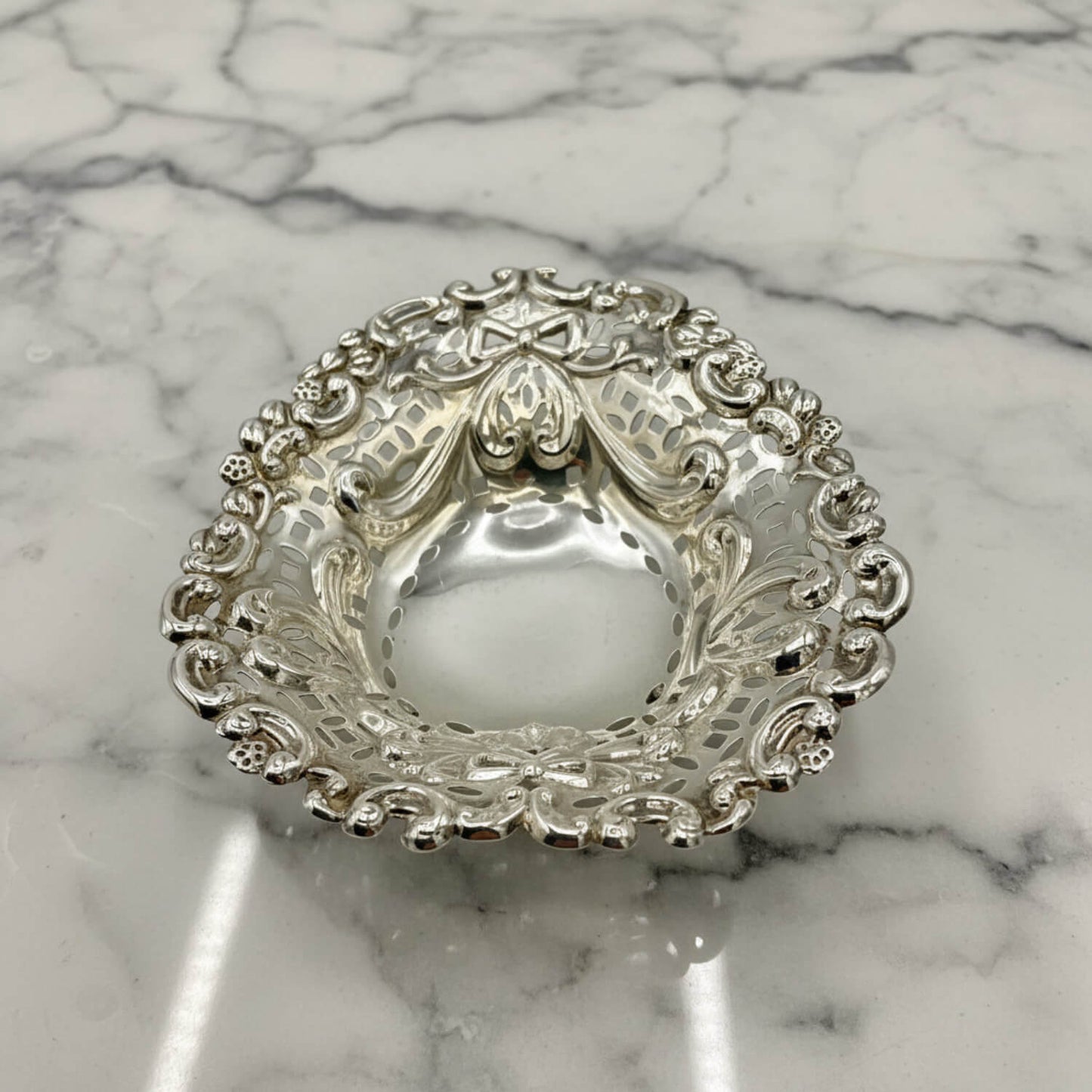 Decorative silver bowl on a marble surface