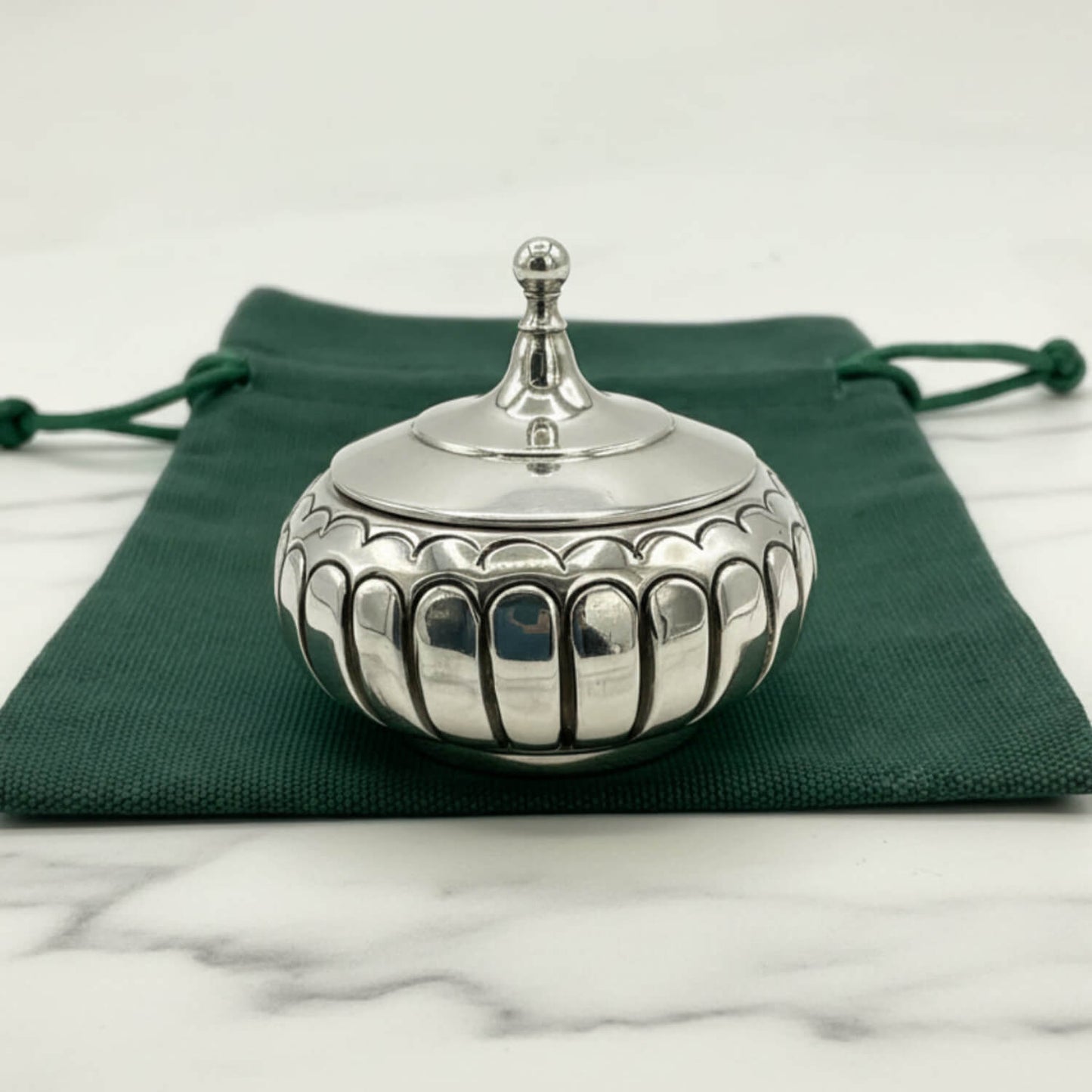 Antique Victorian Sterling Silver Box on a green cloth bag and marble worktop