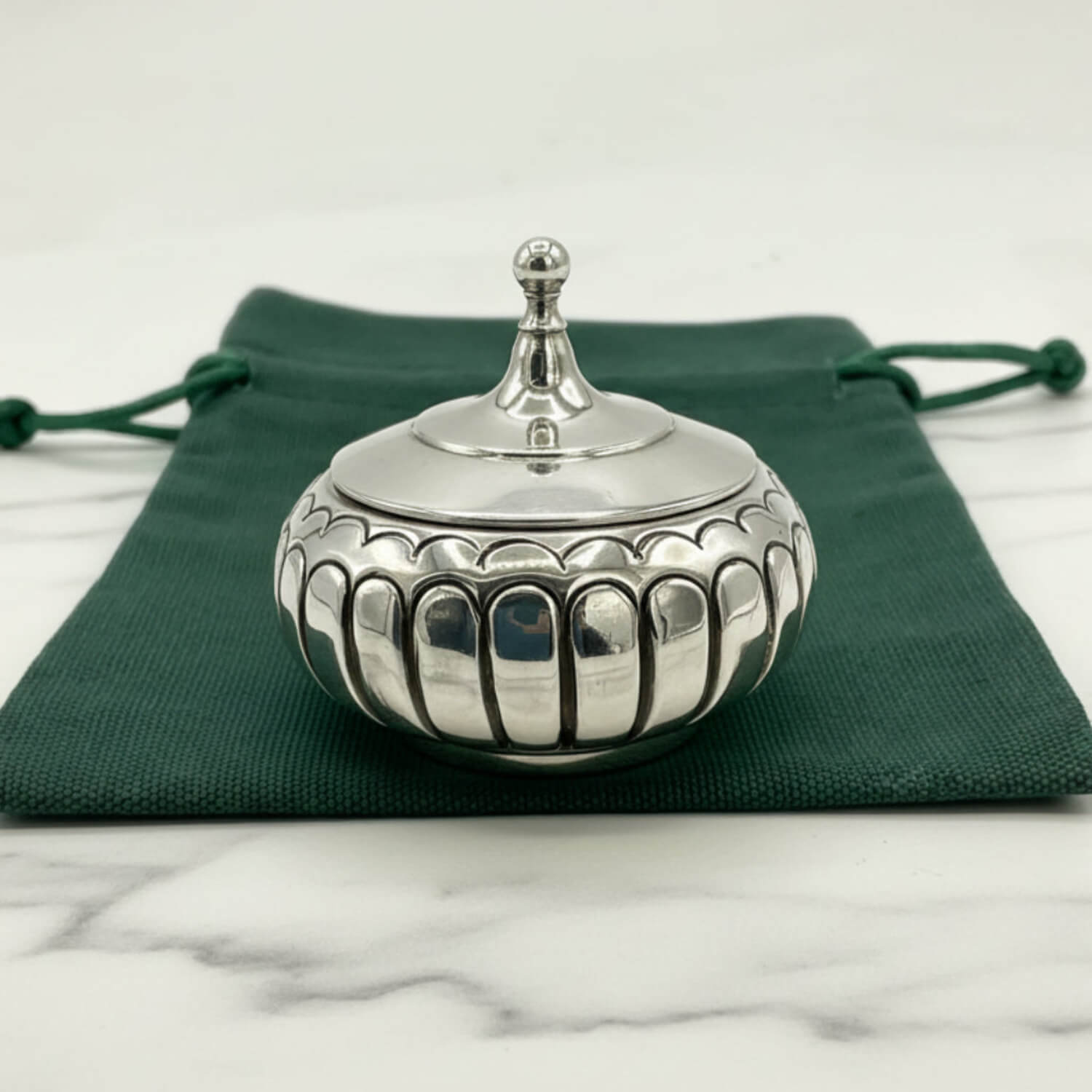 Antique Victorian Sterling Silver Box on a green cloth bag and marble worktop