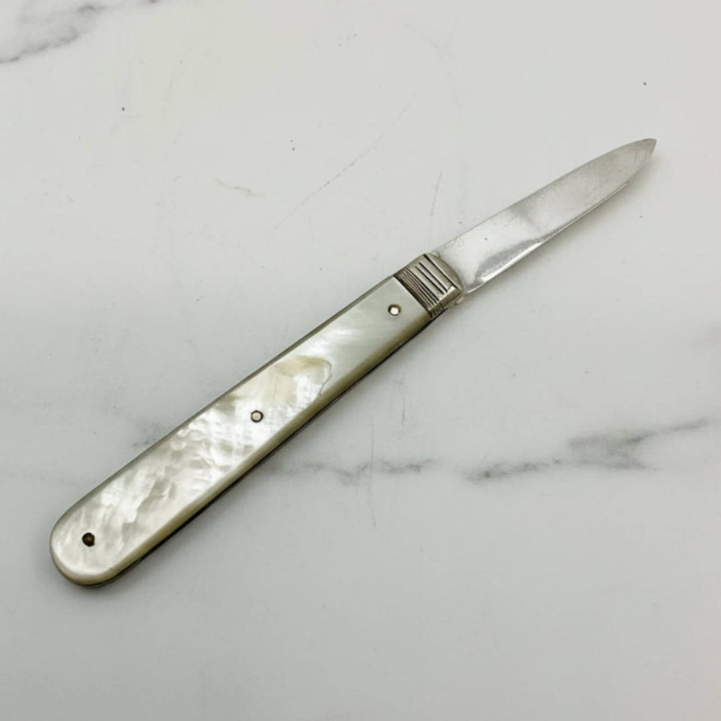 Knife with a decorative handle on a marble surface