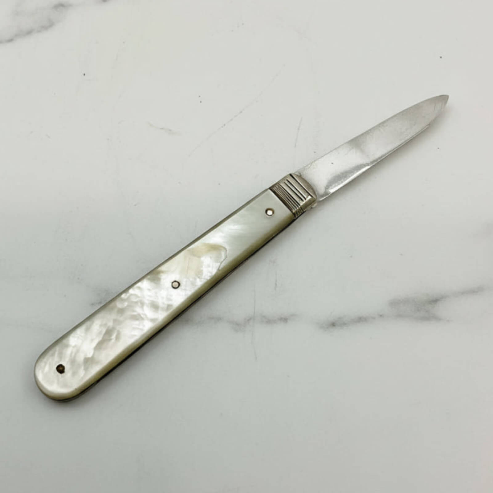 Knife with a decorative handle on a marble surface