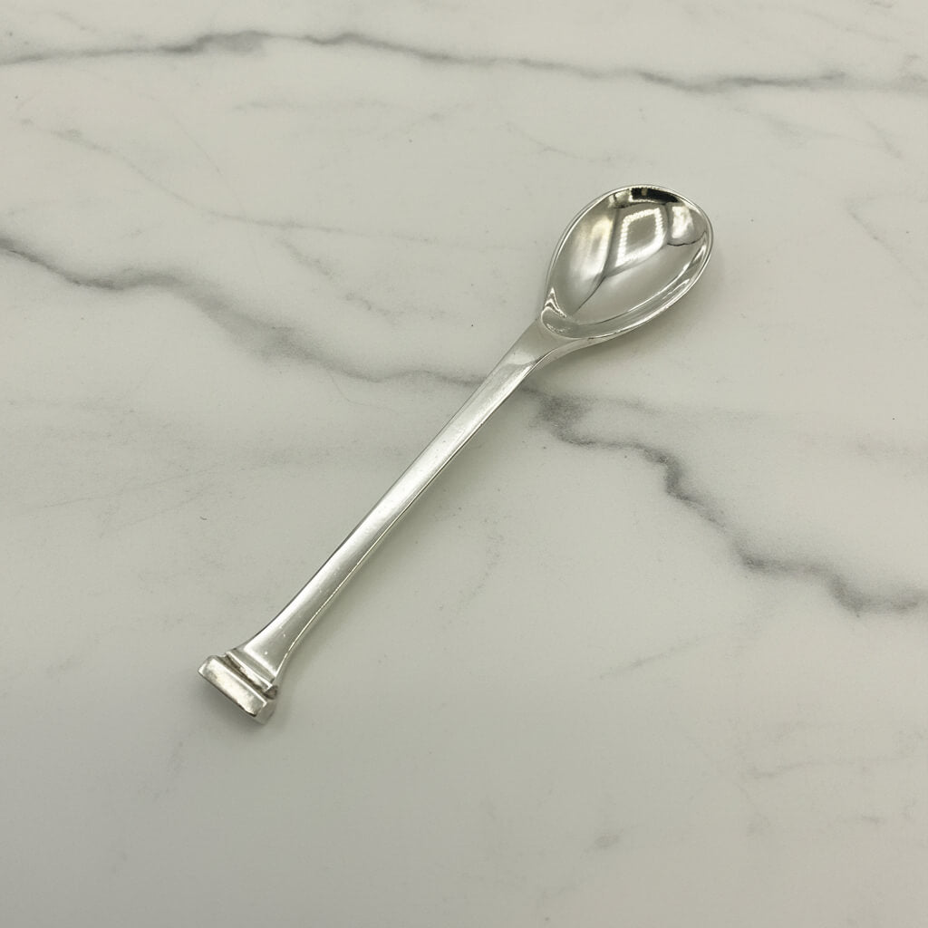 Silver salt spoon on a marble surface
