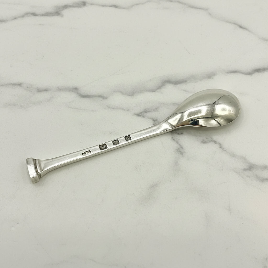 Silver salt spoon on a marble surface