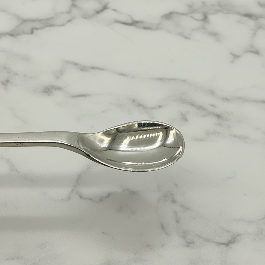 Silver salt spoon on a marble surface