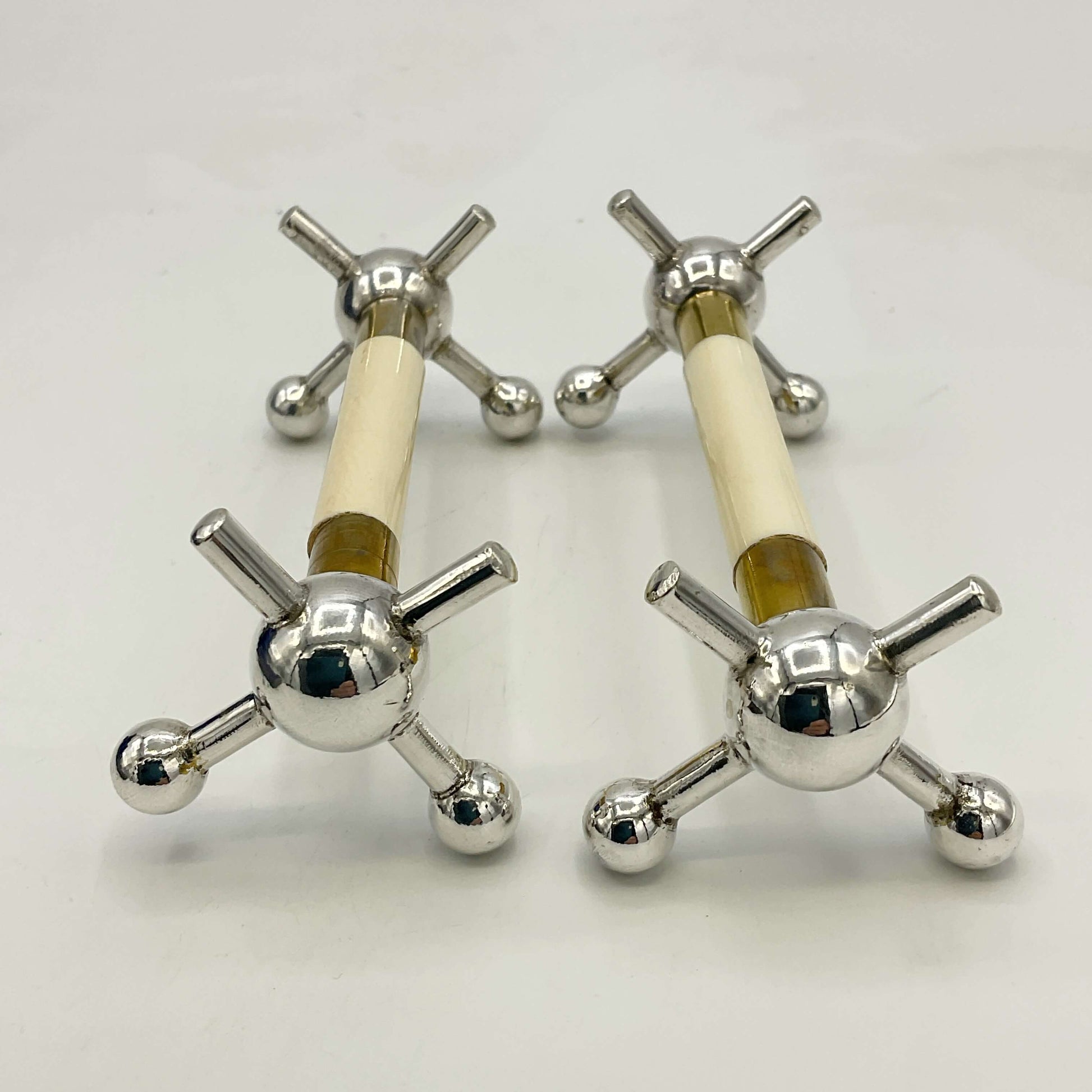 Pair of Antique Silver Plated Knife Rests on white surface