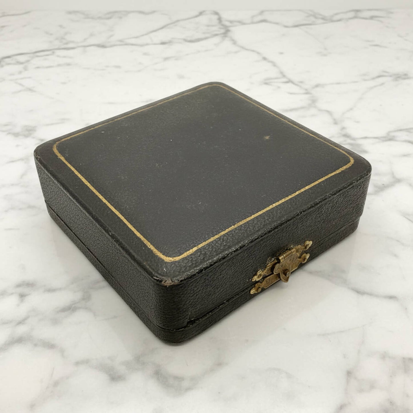 Boxed Pair of Antique Silver Plated Knife Rests on a marble surface