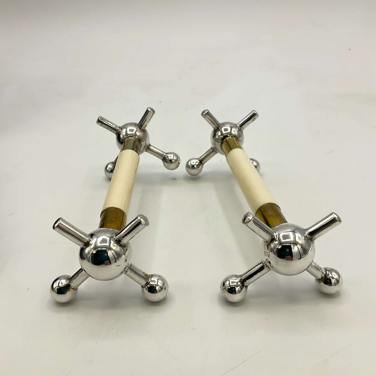 Pair of Antique Silver Plated Knife Rests on a white surface