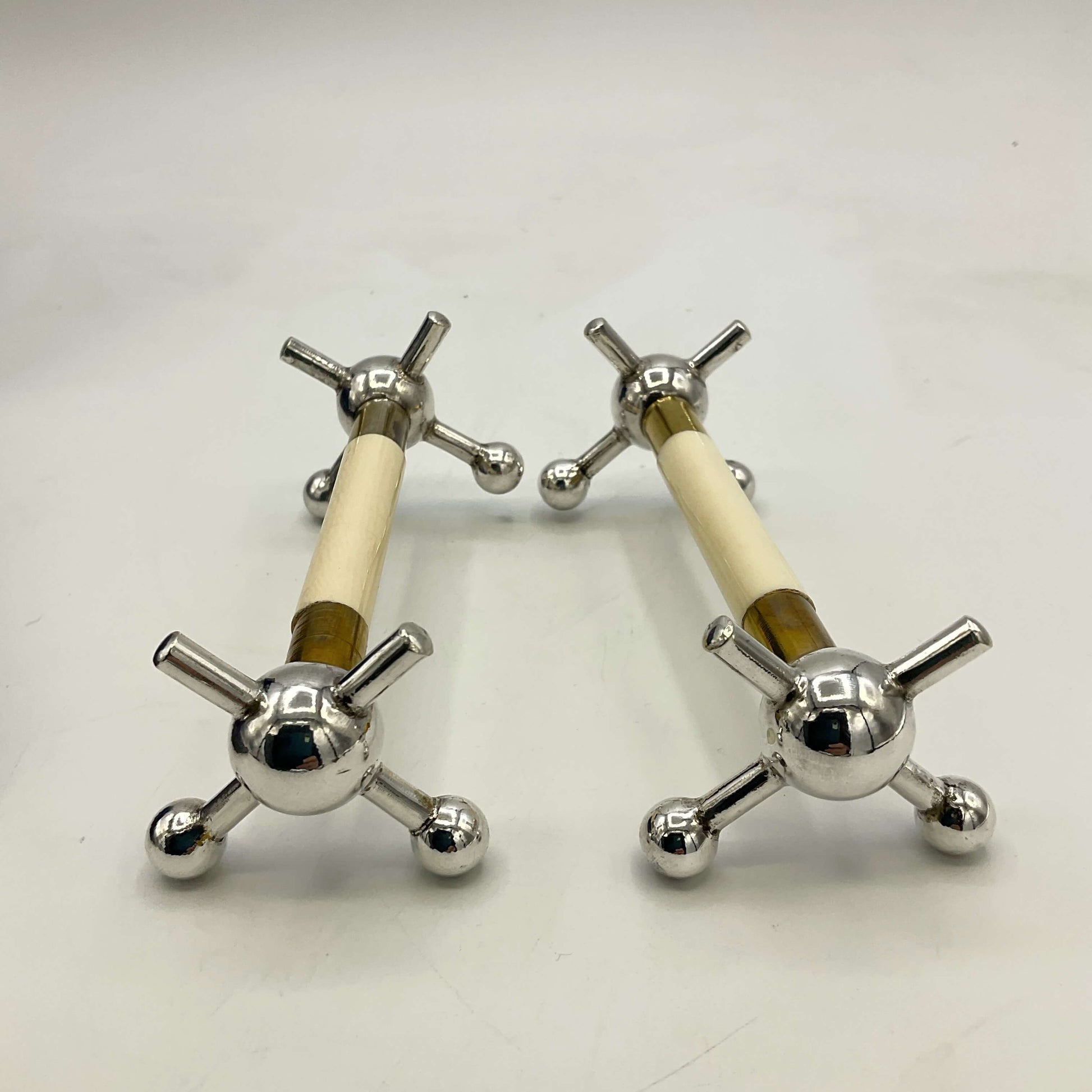 Pair of Antique Silver Plated Knife Rests on a white surface