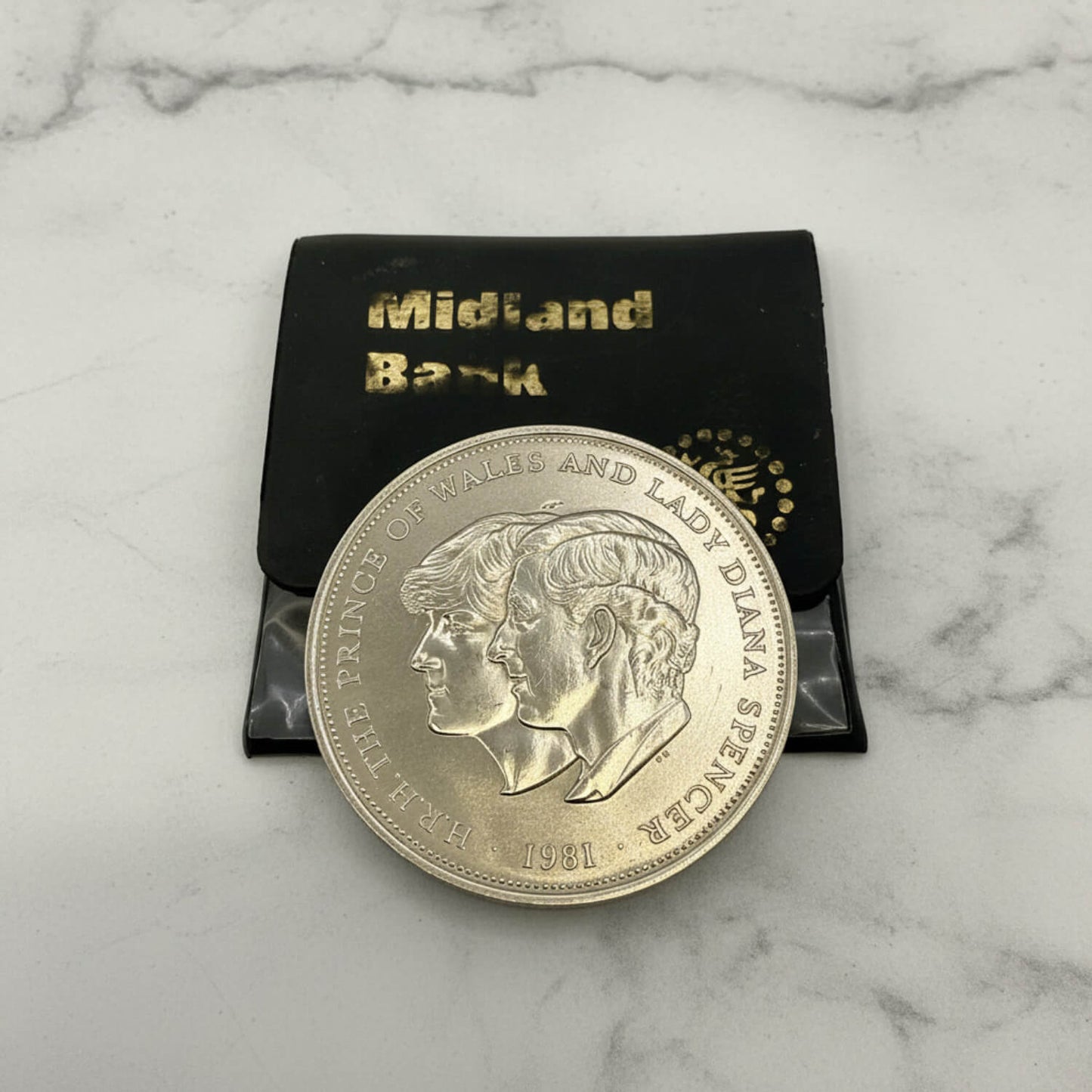 Charles and Diana 1981 Royal Wedding Coin on a marble surface