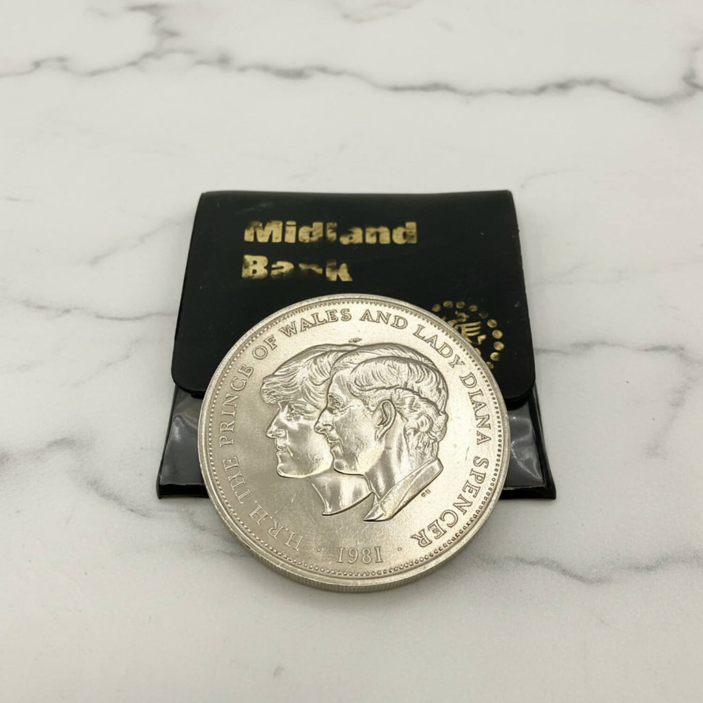 Charles and Diana 1981 Royal Wedding Coin on a marble surface