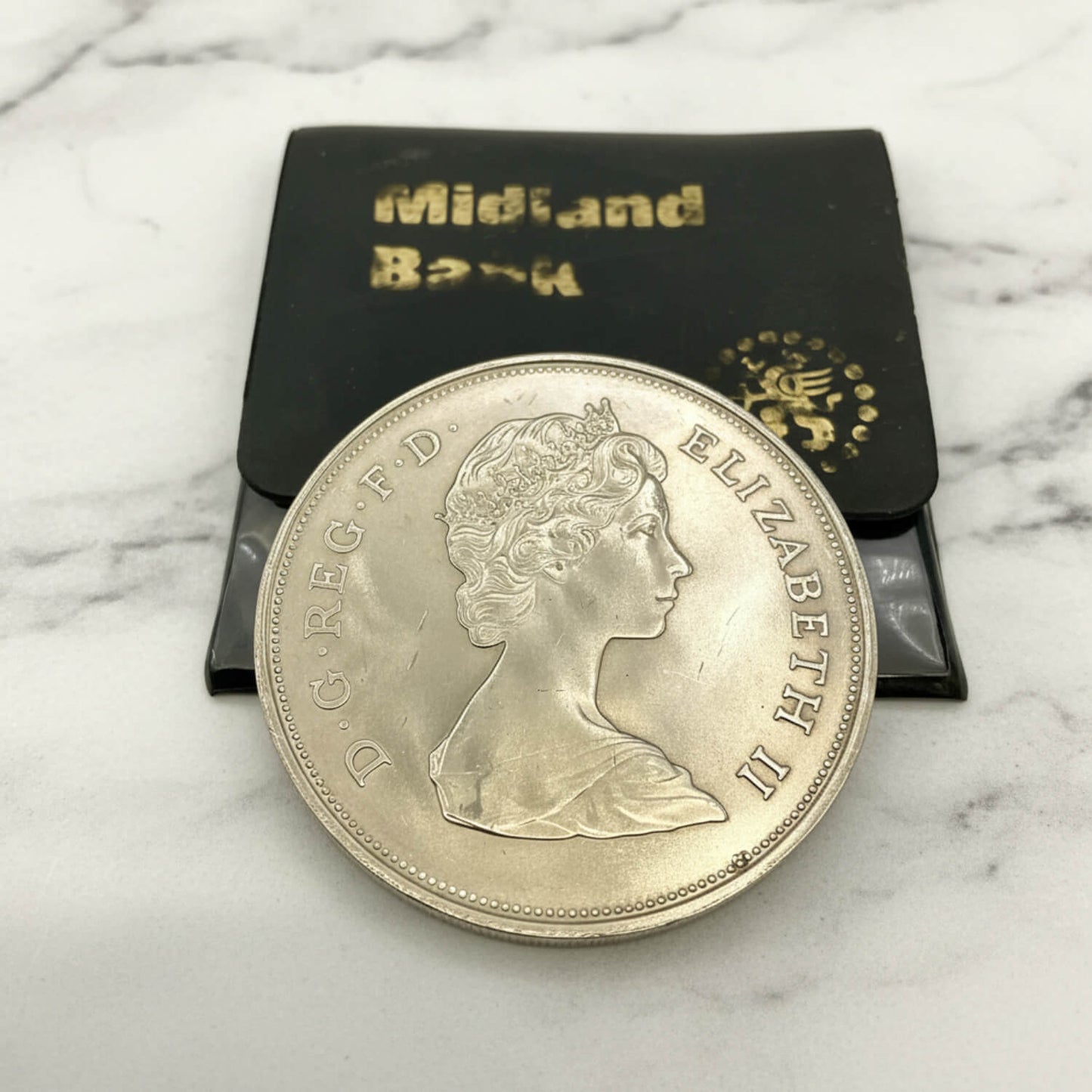 Charles and Diana 1981 Royal Wedding Coin on a marble surface