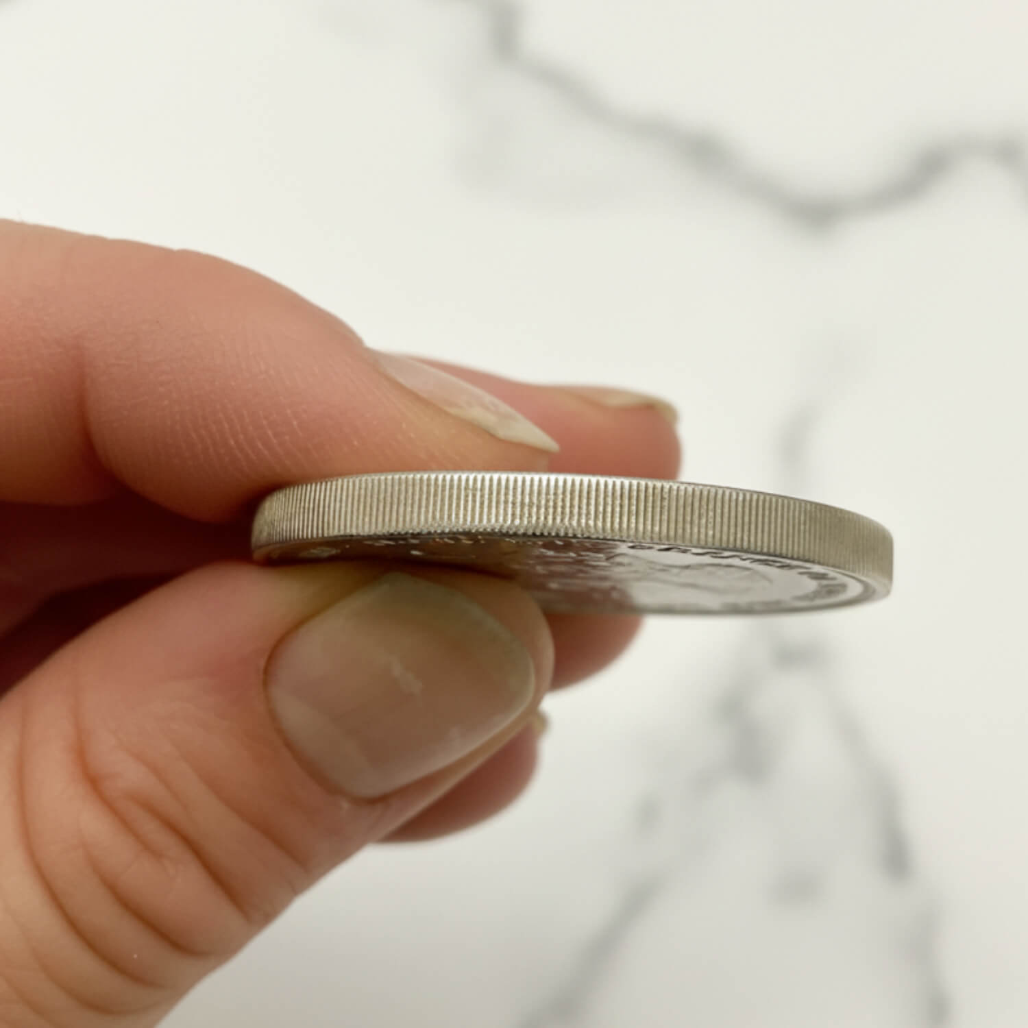 Charles and Diana 1981 Royal Wedding Coin edge held in a hand