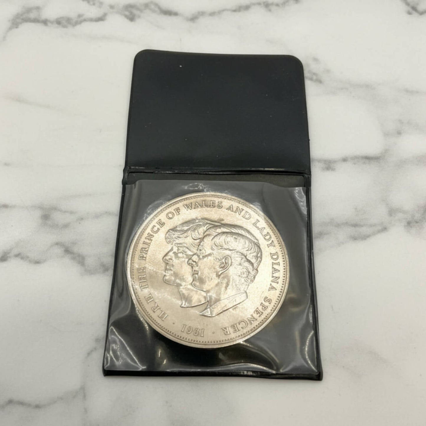 Charles and Diana 1981 Royal Wedding Coin in a case on a marble surface