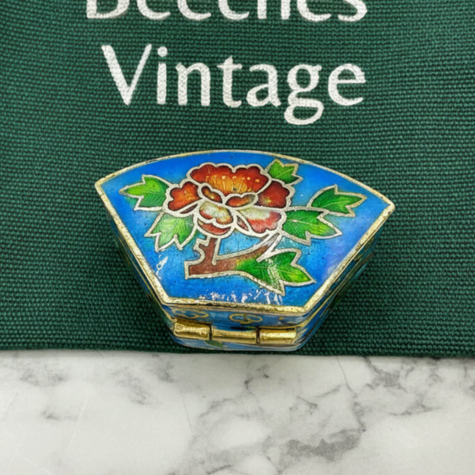 Chinese Cloisonné Enamel Pill Box on a green bag