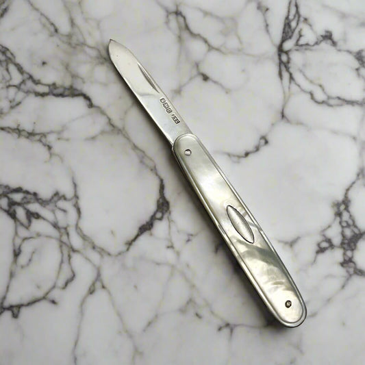 Foldable  fruit knife on a marble surface