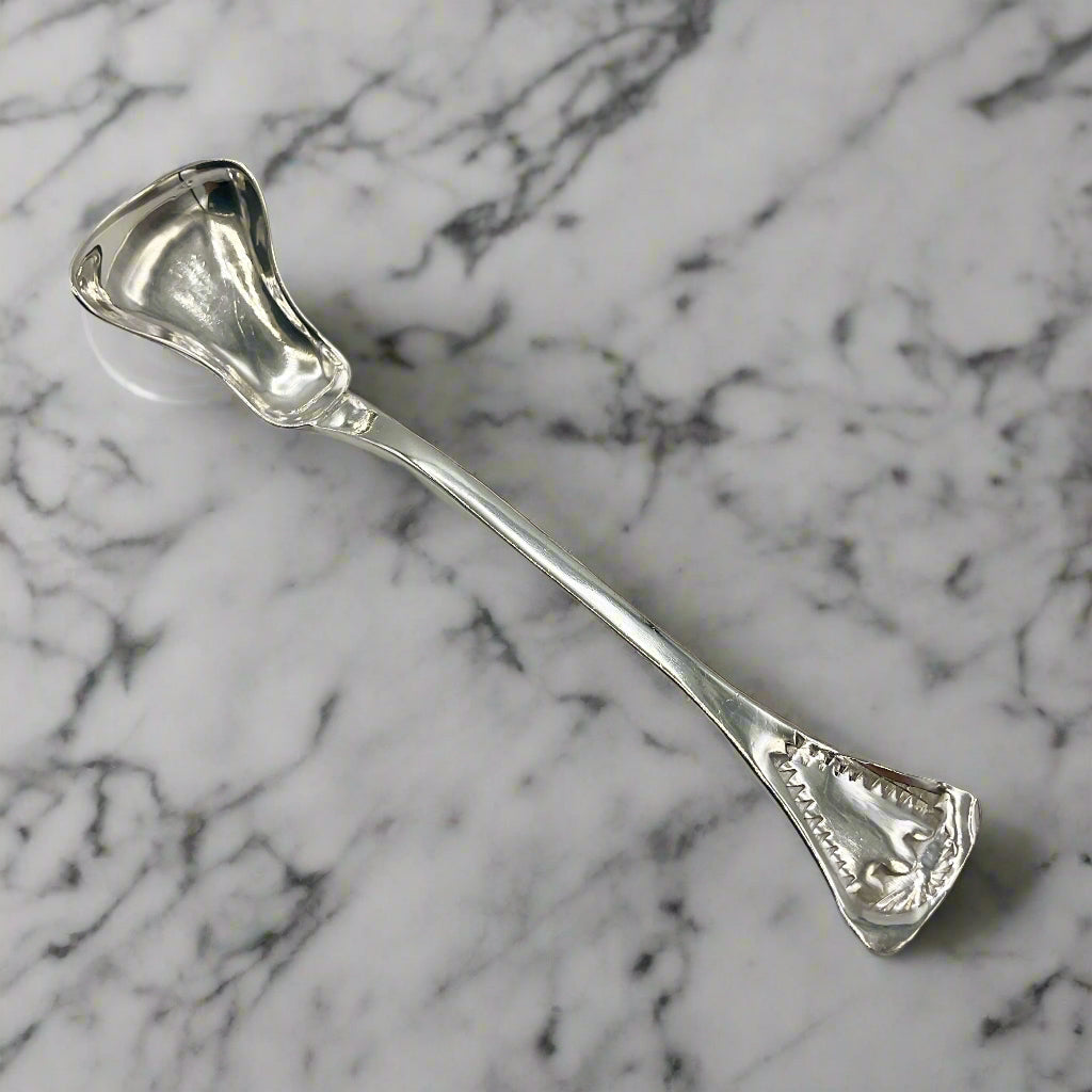 Silver spoon on a light marble background