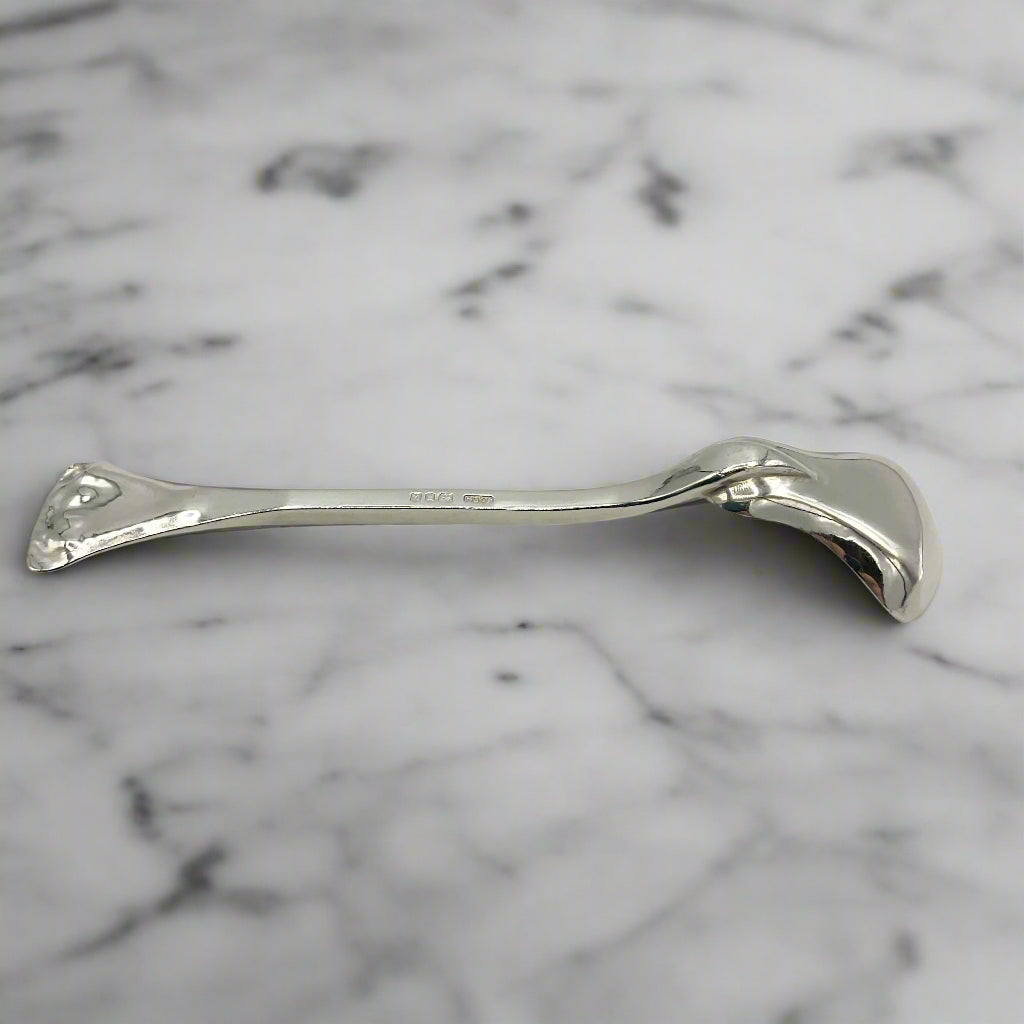 Silver spoon on a light marble background