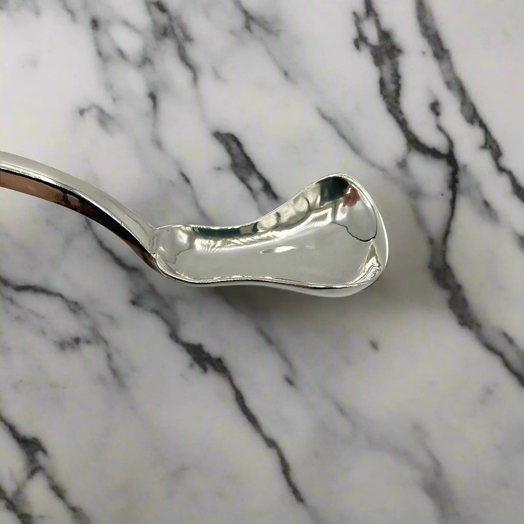 Silver spoon on a marble surface