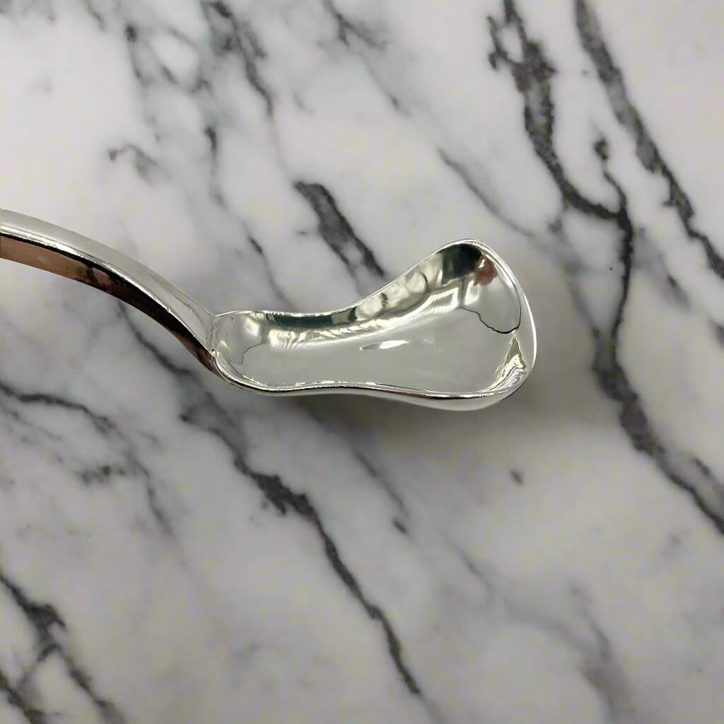 Silver spoon on a marble surface