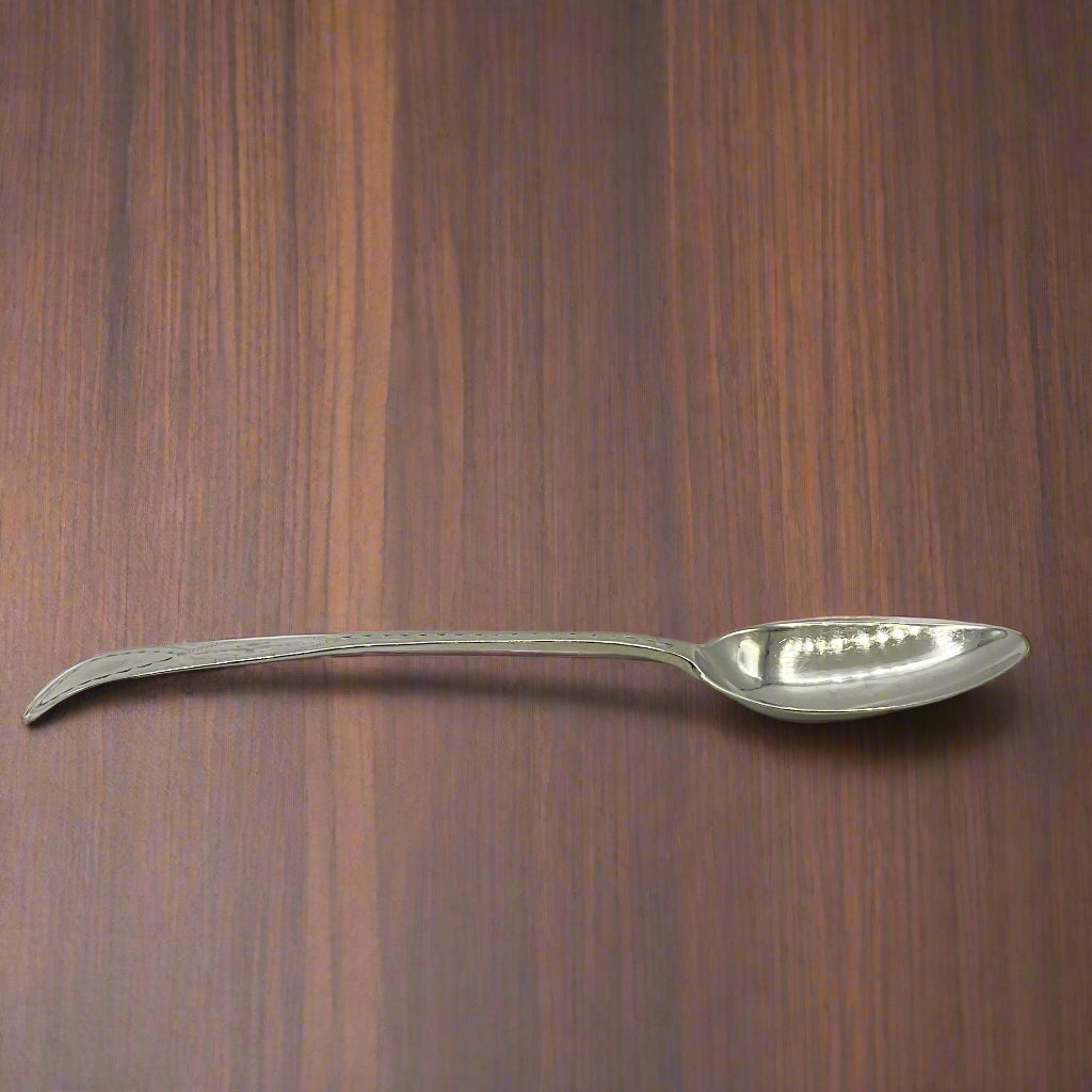 Silver spoon on a wooden table