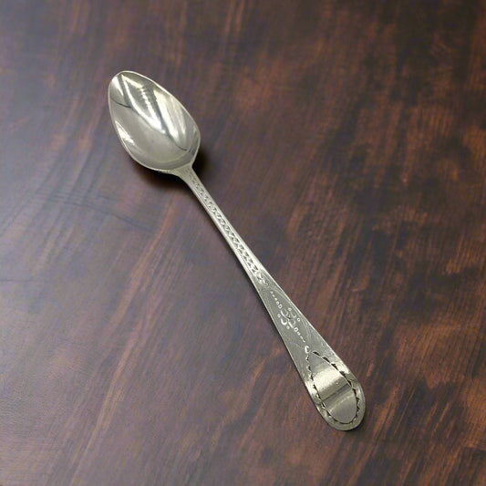 Silver spoon on a wood table