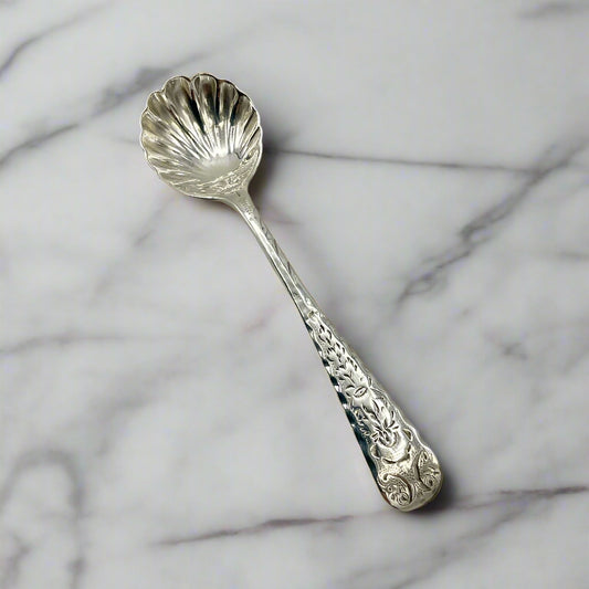 Decorative silver spoon on a marble background