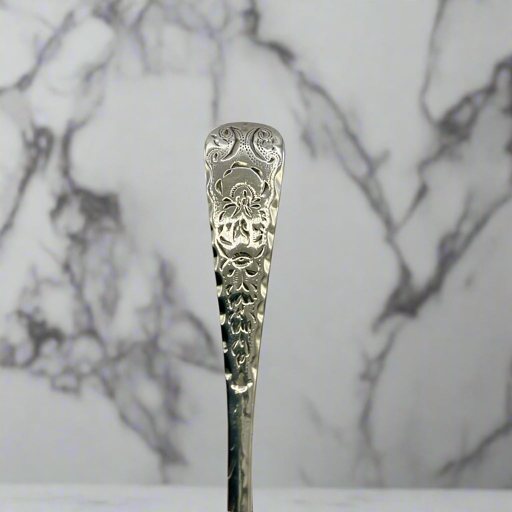 Decorative silver spoon against a marble background