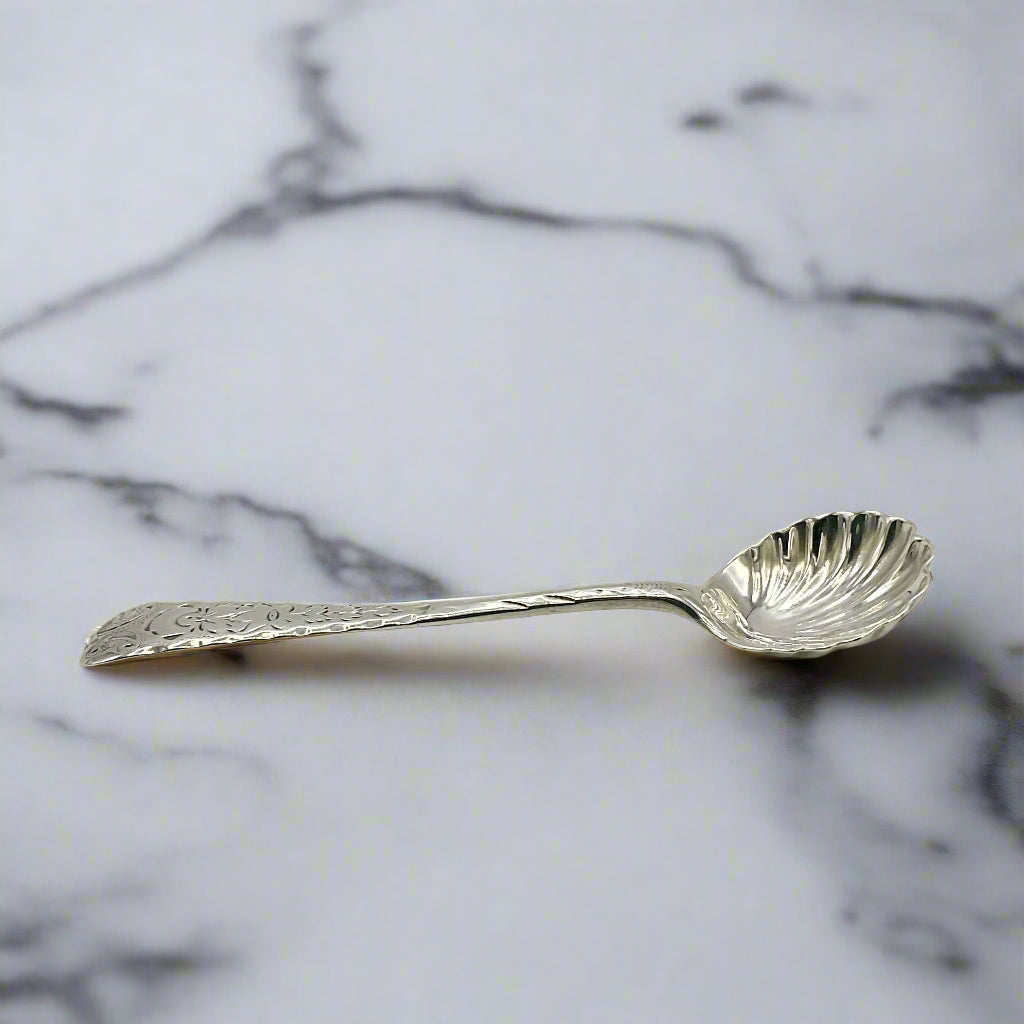 Decorative silver spoon on a marble surface