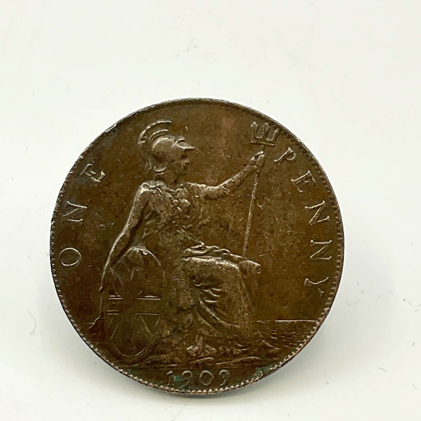 Antique one penny coin with Britannia on with a granite surface