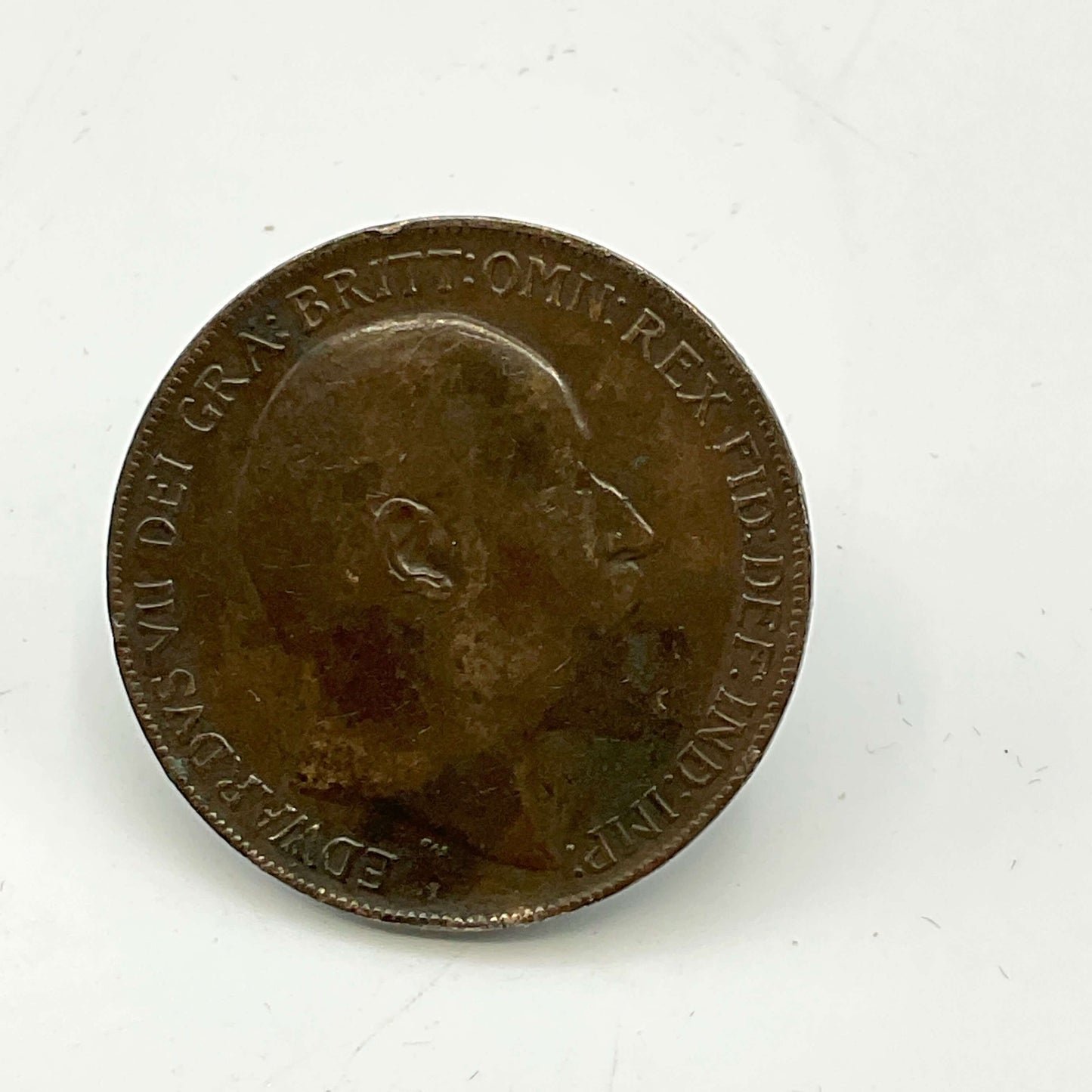 Antique one penny coin with engraved portrait on a white background