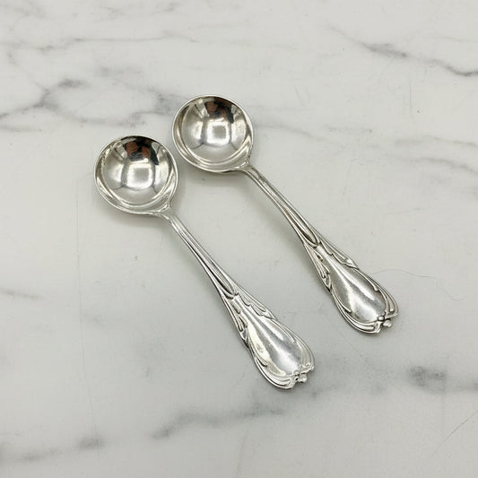 Two silver spoons on a marble background