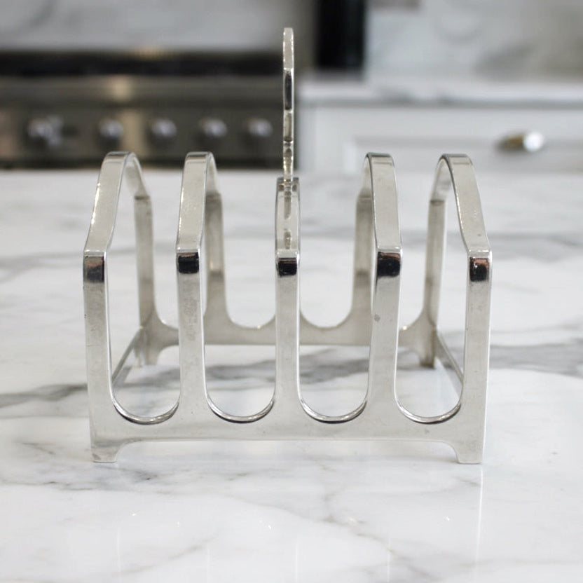 Silver toastrack on a marble countertop with kitchen background