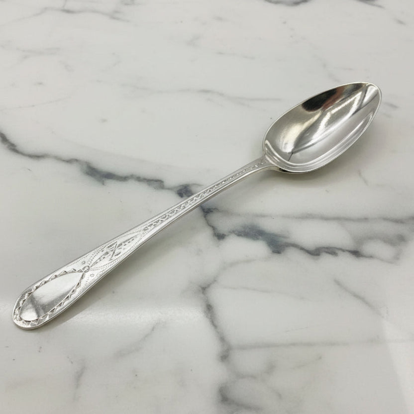 Silver spoon on a marble surface