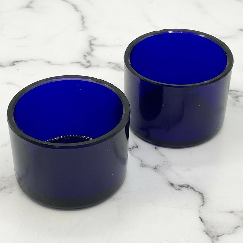 Two blue glass liners on a marble background