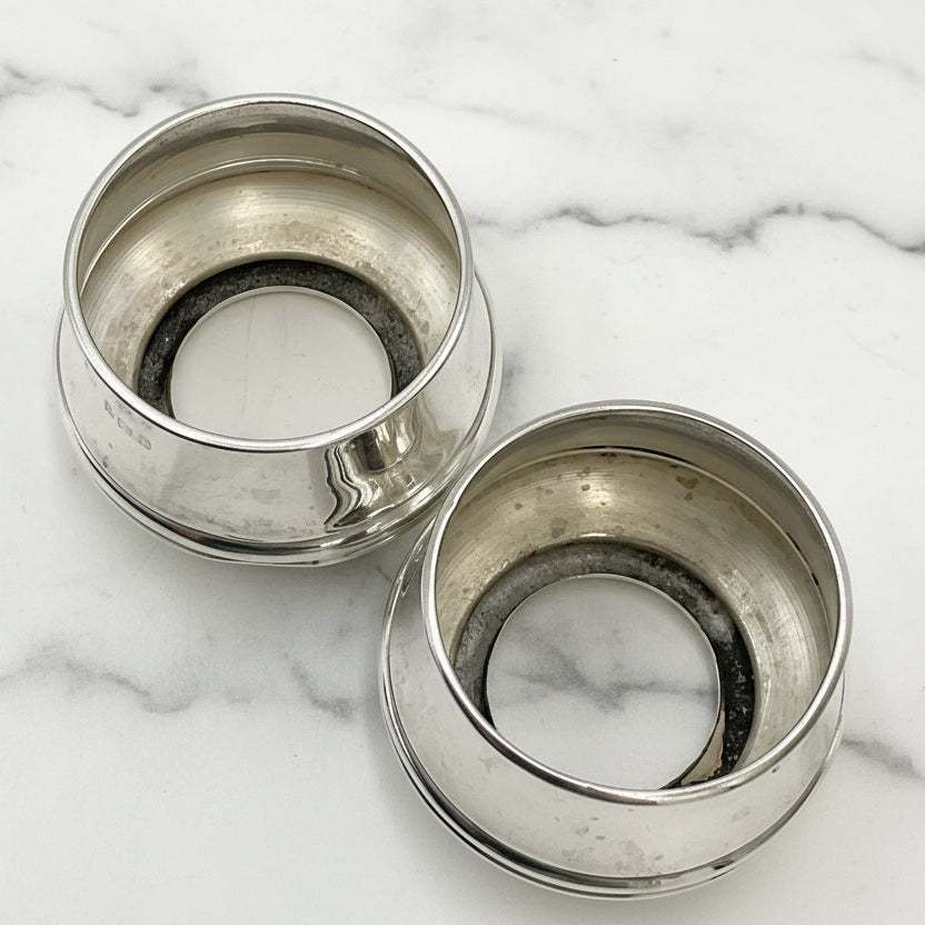 the interiors of two silver salts on a marble surface