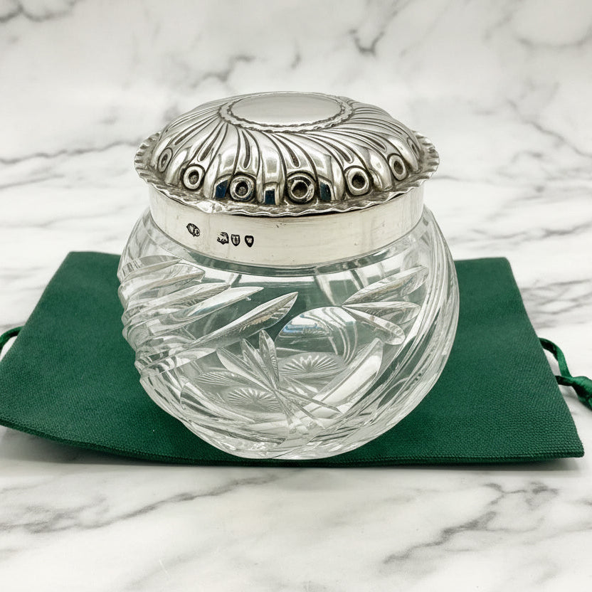 Clear glass jar with silver lid on a green cloth