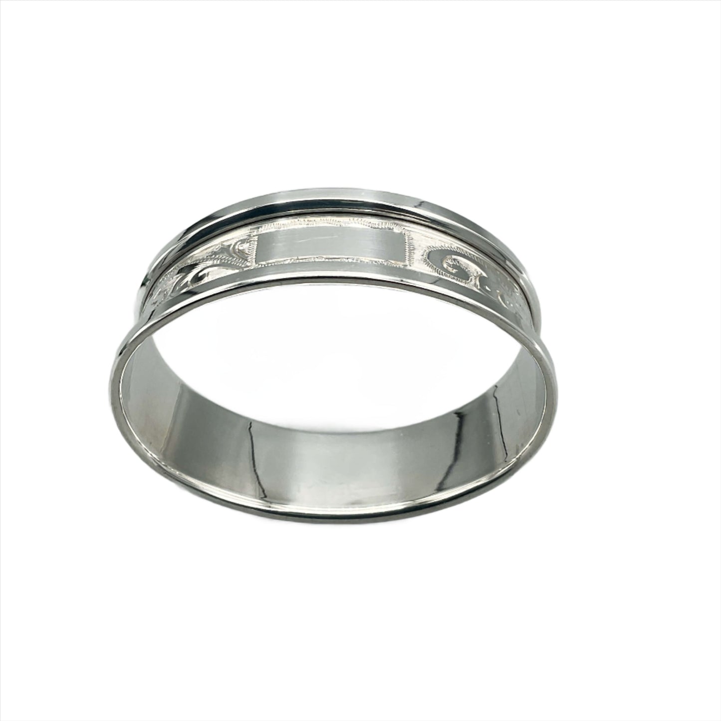 Silver napkin ring with blank rectangular cartouche and etched flower pattern on a plain background