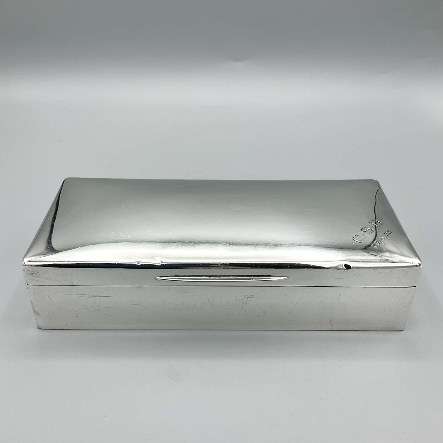 large shiny antique silver cigarette box on a white background