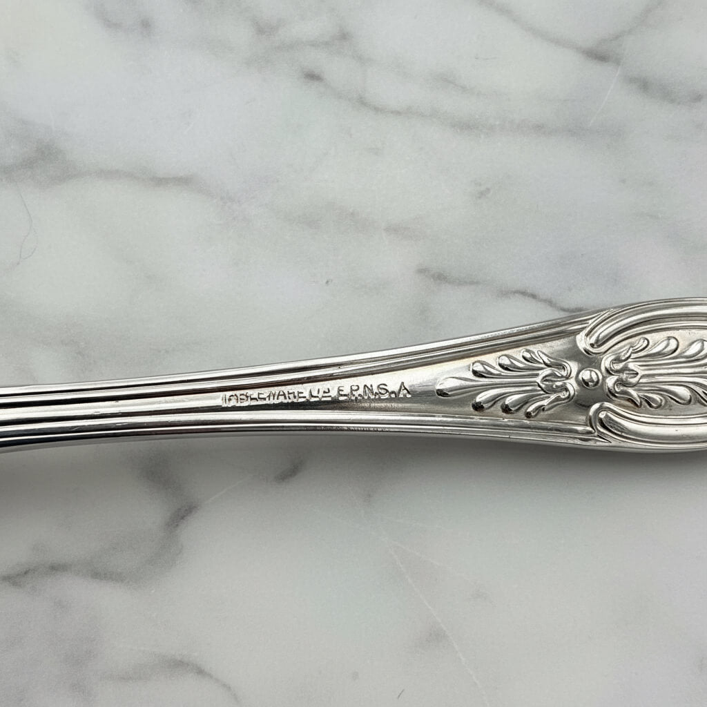 Tableware EPNS A1 imprinted on the back of a spoon handle with a marble background