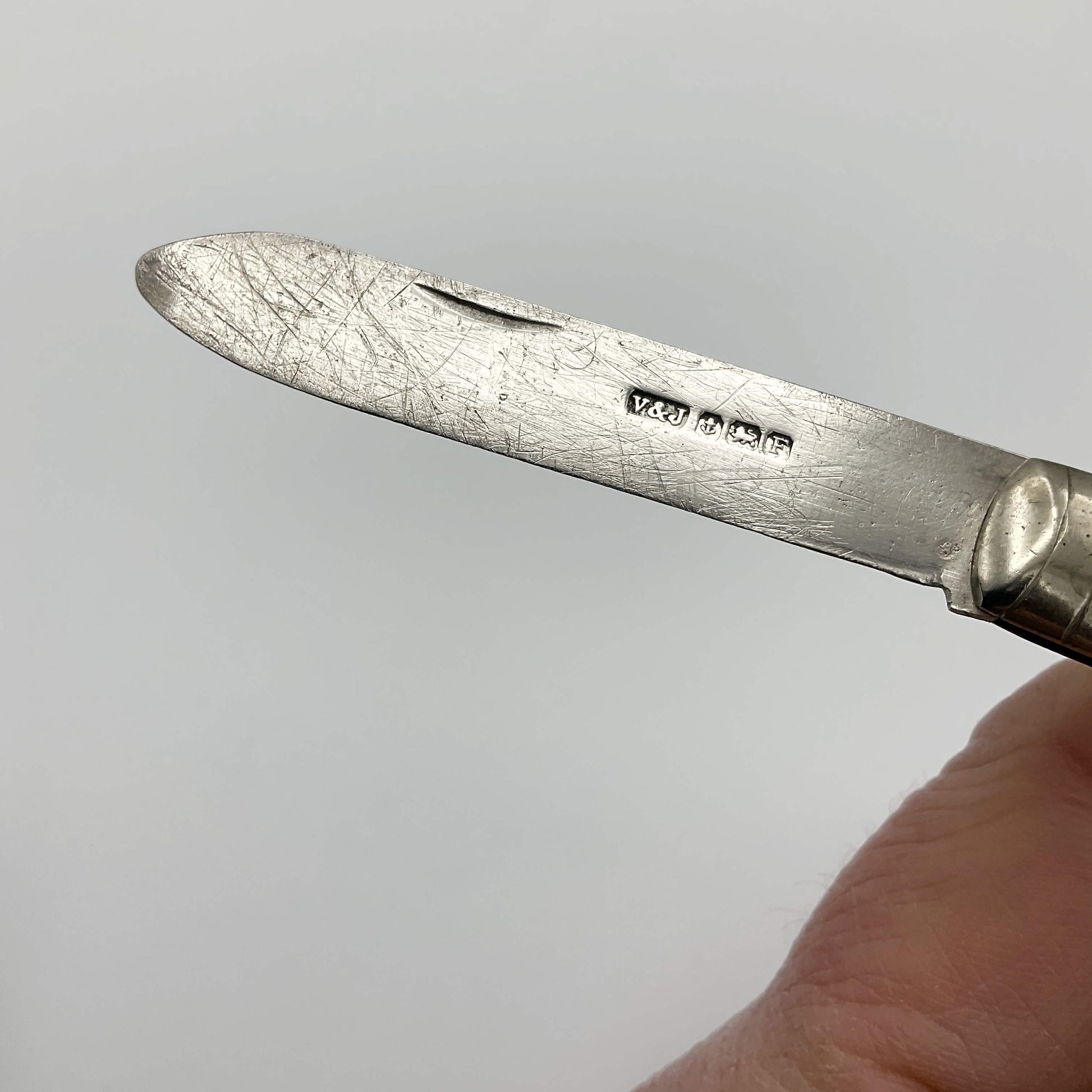 Vintage silver fruit knife with a blade showing the hallmarks