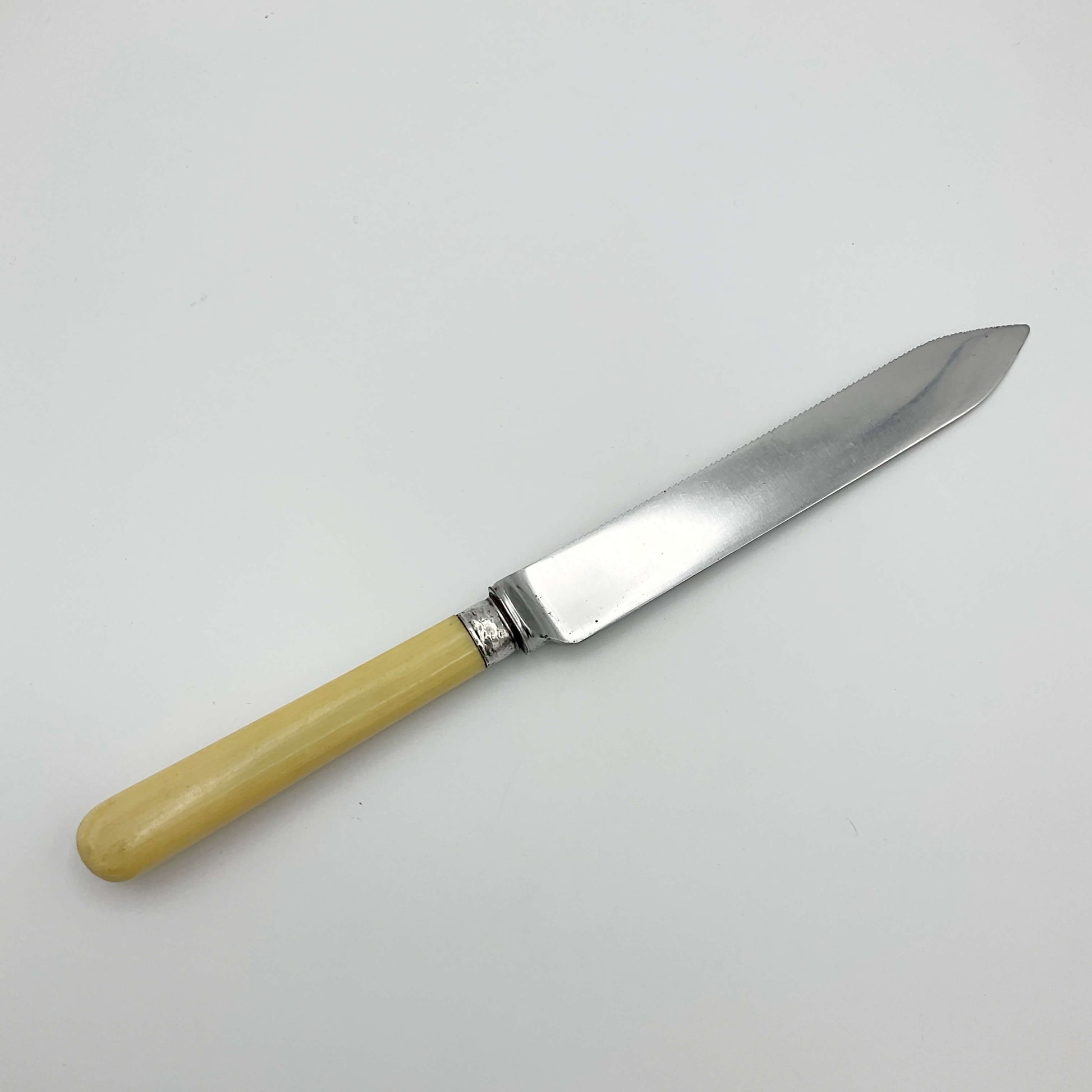 Cake knife with pointed end on white background 