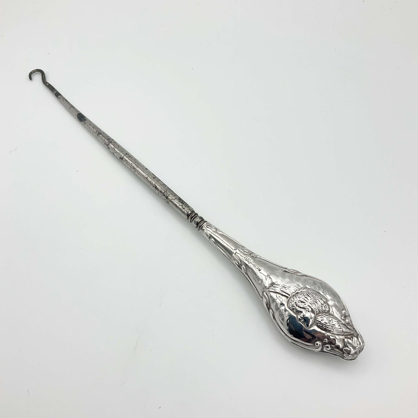 Beautiful large antique silver button hook featuring a cherub on the handle