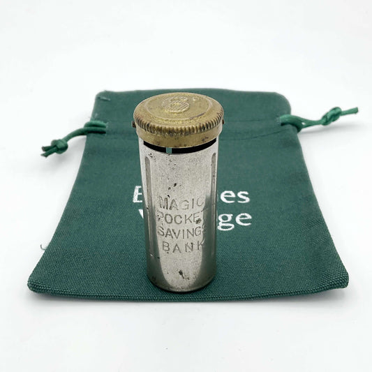 Vintage coin holder called the Magic Pocket Savings Bank on a green cotton bag.