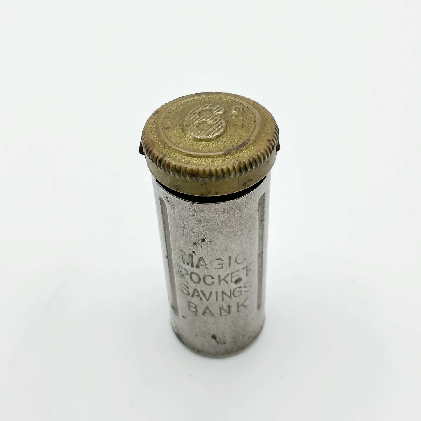 Vintage coin holder called the Magic Pocket Savings Bank on a white background