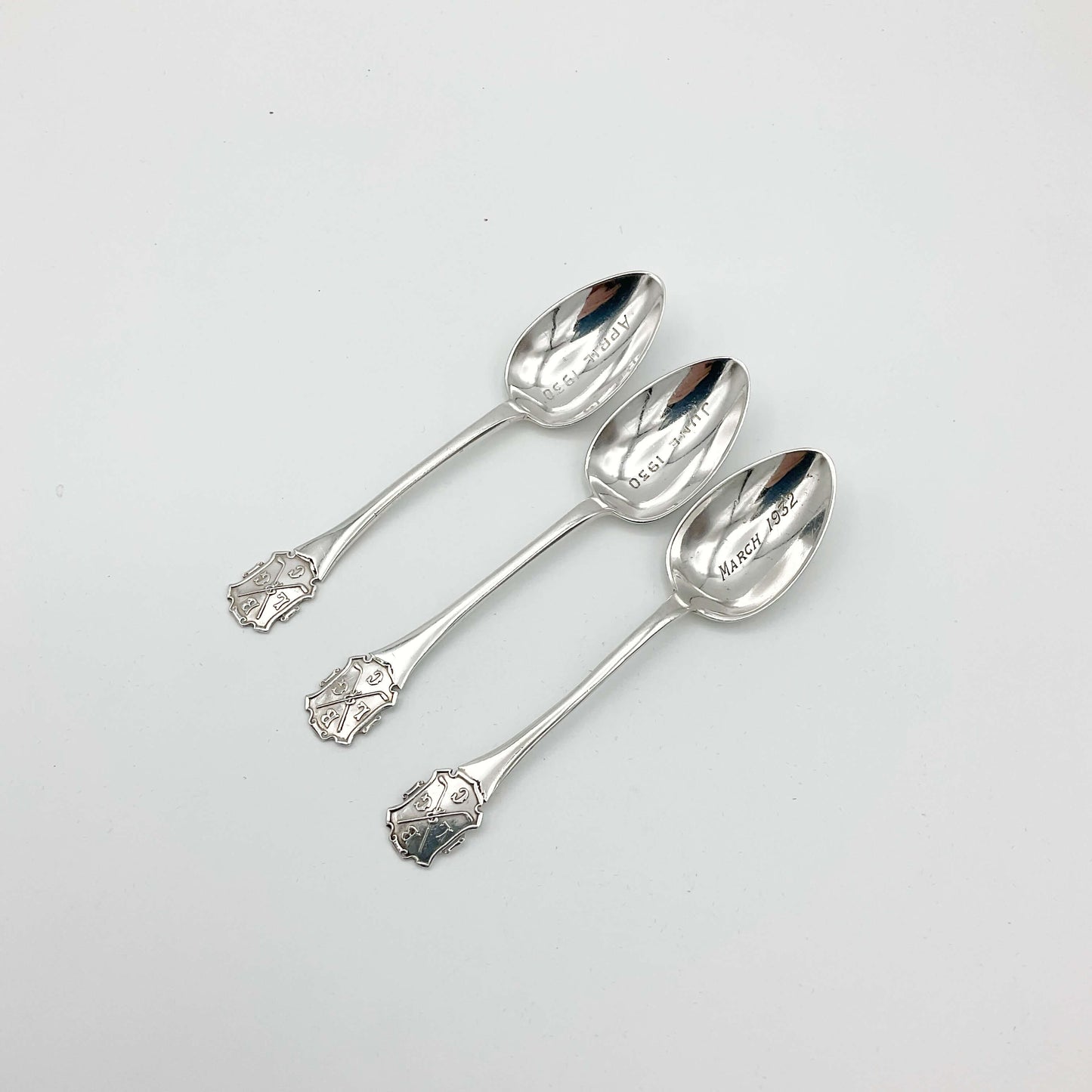 Three coffee spoons with 1930s dates in the bowls and BLGC logos on the handles
