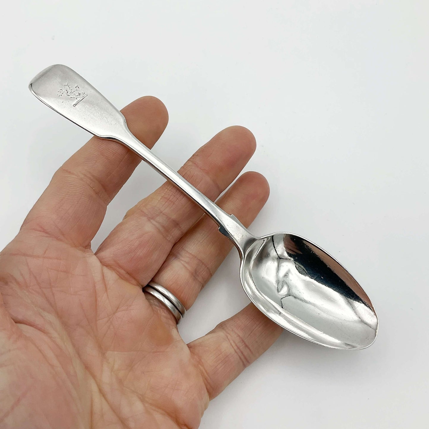 Antique Silver Teaspoon held in a hand