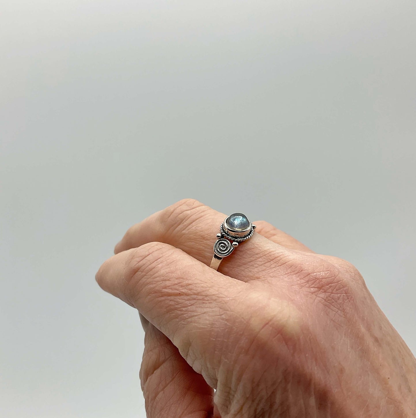 Blue moonstone silver ring on a finger