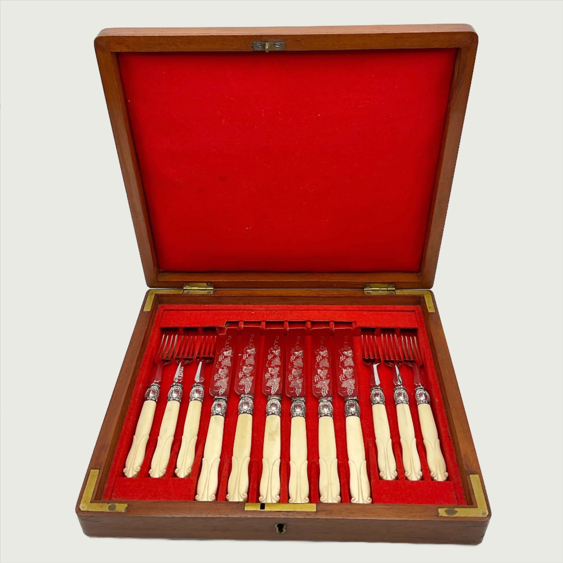 Antique silver plated dessert knives and forks with bone handles in a red lined wooden presentation box